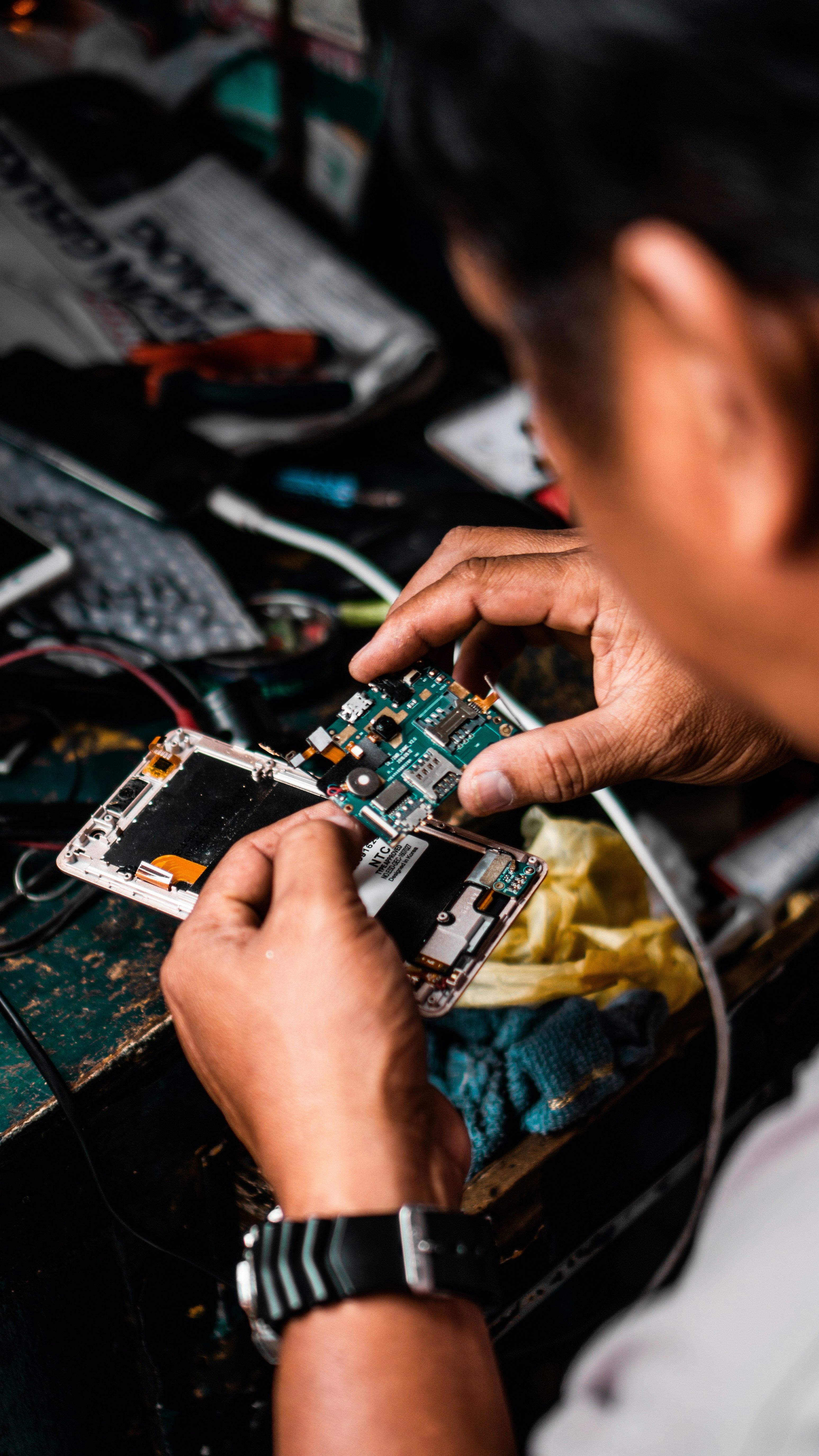 Technician performing electronics repair