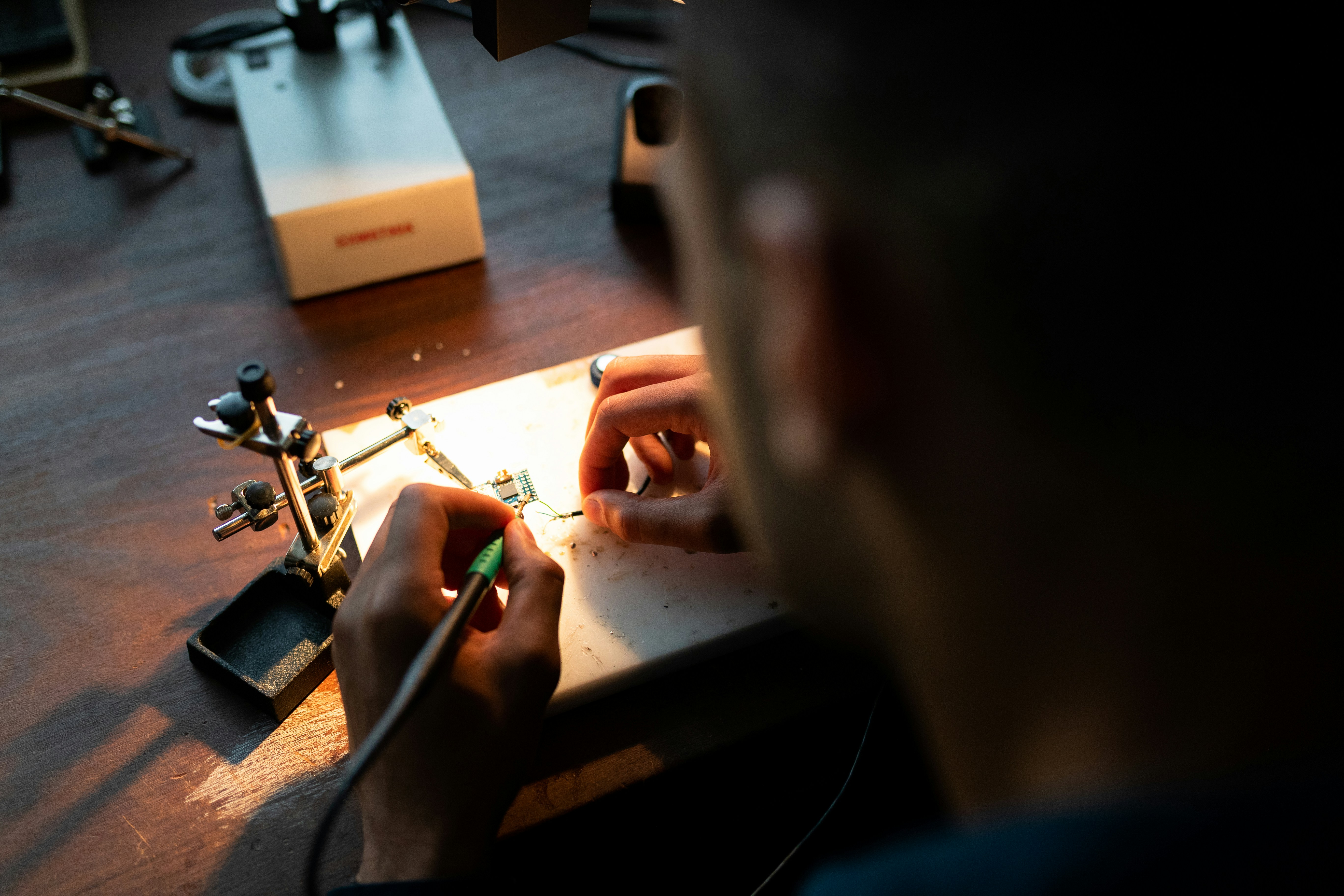 Technician soldering components on a circuit board